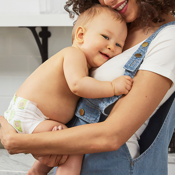 A heartwarming image of a tender moment between a mother and her baby, as the little one reaches out to hug their loving parent.