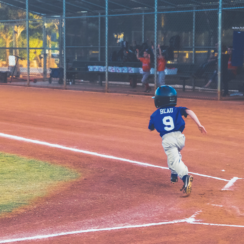 A young athlete ready to hit a home run