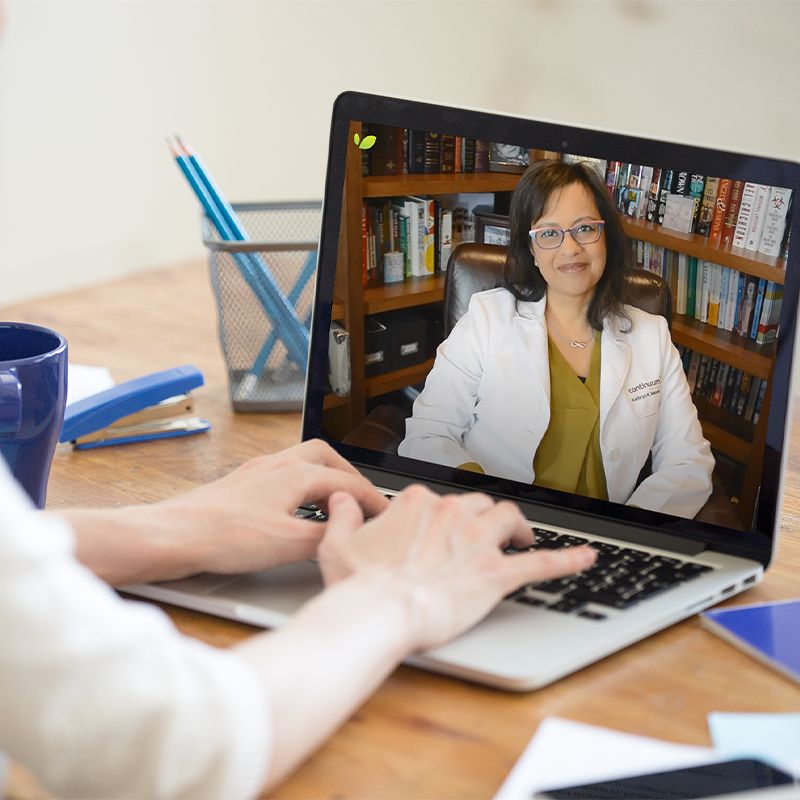 A patient consults with their doctor through a virtual telemedicine appointment, utilizing technology to bridge the distance between healthcare provider and patient.