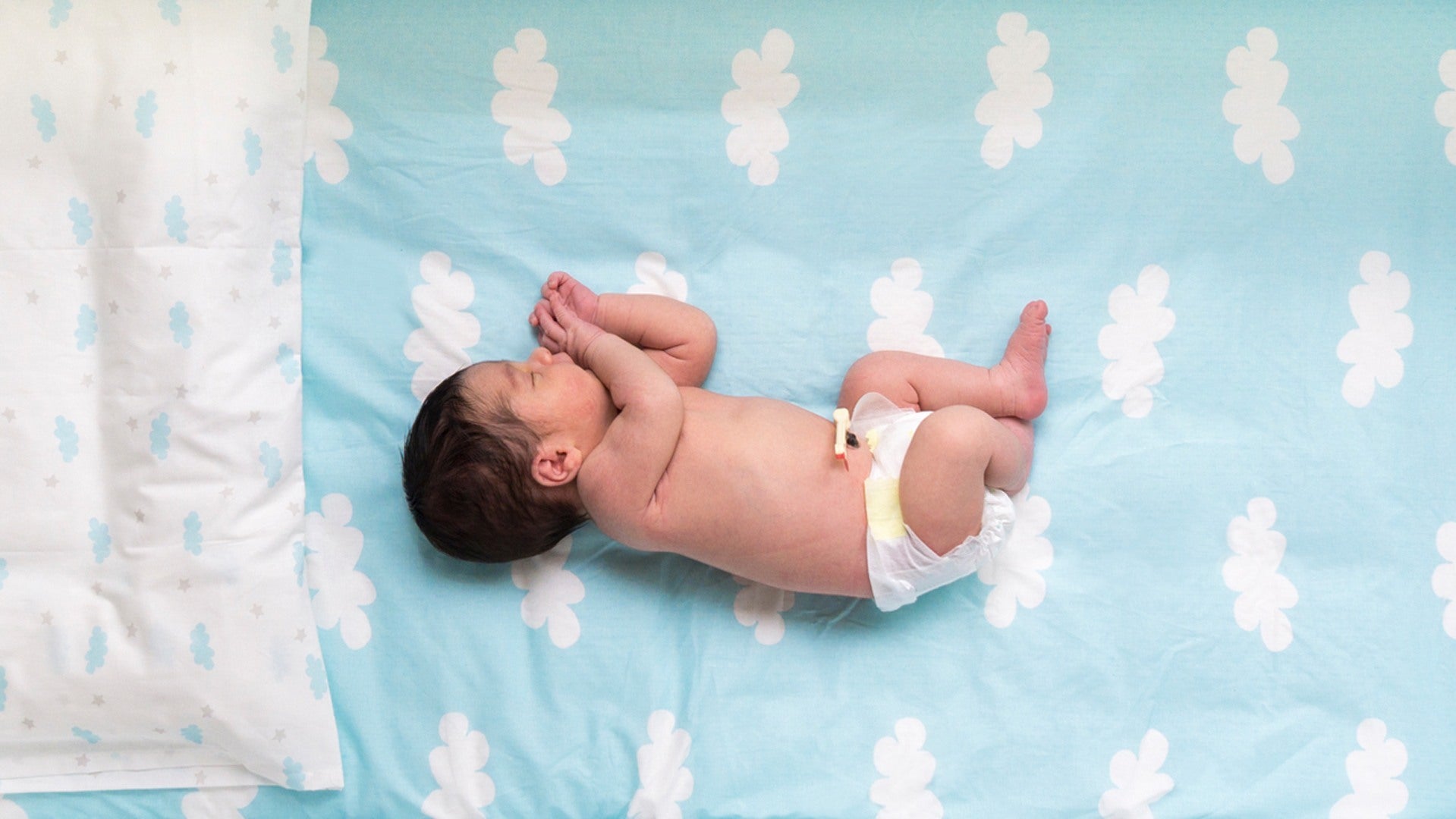 Newborn sleeping on blanket