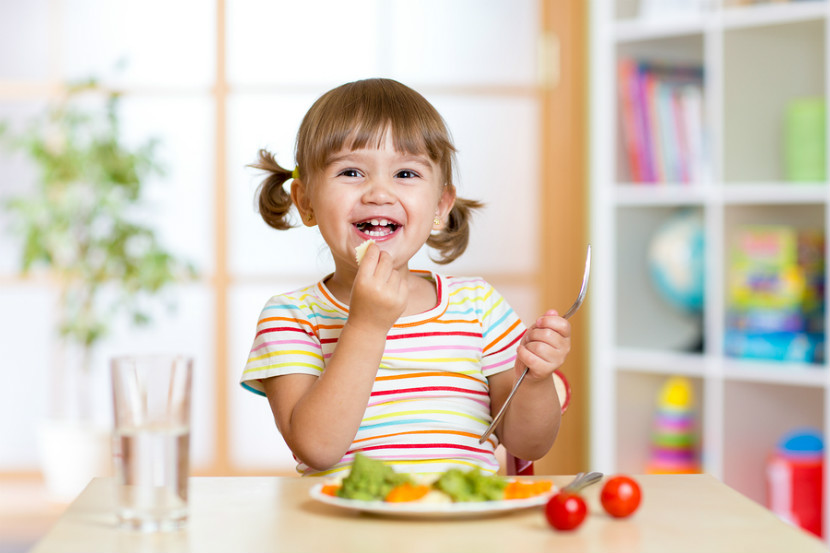 A growing toddler enjoys a protein-packed meal.