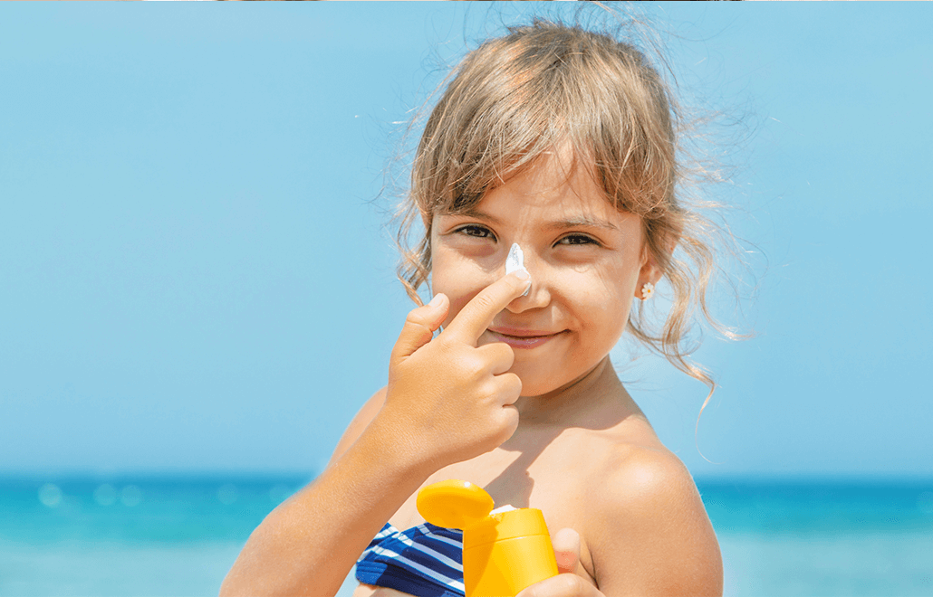 A child applying sunscreen to their skin, protecting themselves from harmful UV rays.