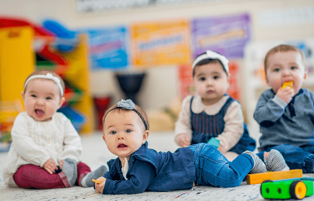 A group of adorable toddlers, full of curiosity and energy, pose for the camera.