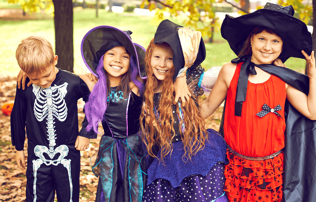 Children, dressed in adorable Halloween costumes, trick-or-treating, sharing the joy of the spooky season.