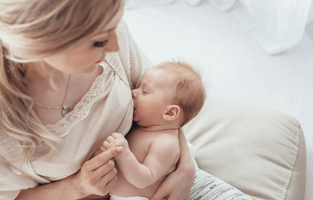 A mother tenderly breastfeeds her baby, providing essential nourishment and comfort.