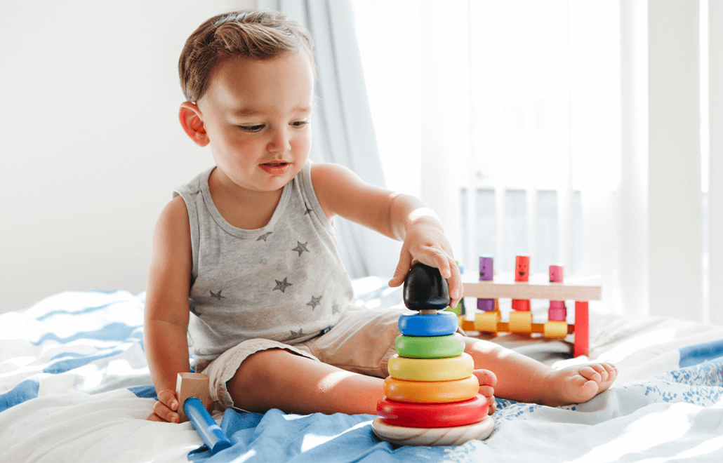 A baby actively engages in age-appropriate activities as recommended by pediatricians for optimal early childhood development.