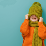 Child bundled up in winter clothes, staying warm to support immune health