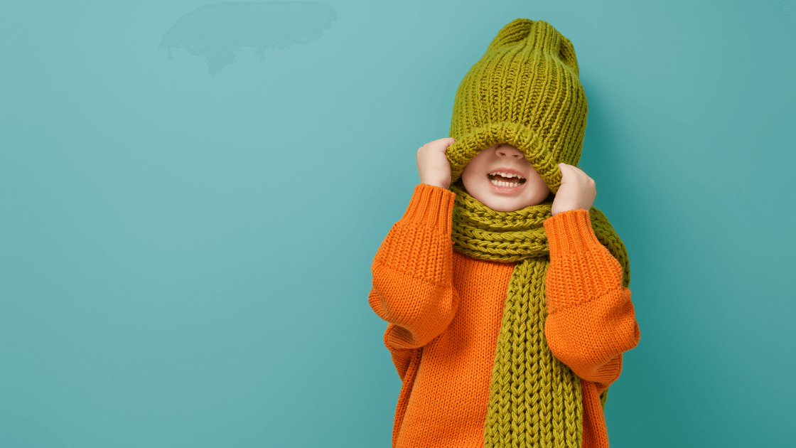 Child bundled up in winter clothes, staying warm to support immune health