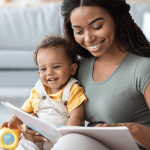 Parent reading a storybook to a smiling baby